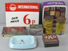 A group of vintage shop display tins along with a Wade Johnnie Walker bar ashtray