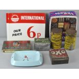 A group of vintage shop display tins along with a Wade Johnnie Walker bar ashtray