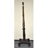 A turned mahogany standard lamp on a 19th century base,