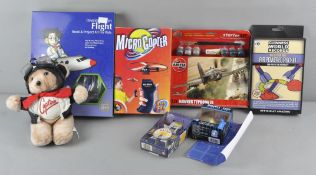 A collection of assorted toys and games, including an Airfix model aircraft kit,