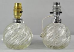 A pair of Pressed glass bulbous table lamps of globe form with spiral decoration,
