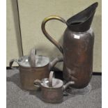 A large copper coal scuttle along with other copperware,