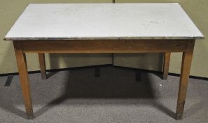A 20th century beech wood school table raised on square tapering legs. Measures; 76cm x 137cm.