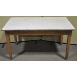 A 20th century beech wood school table raised on square tapering legs. Measures; 76cm x 137cm.