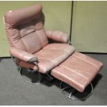 A revolving reclining chair with stool,