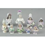 A collection of assorted ceramic pin cushion ladies, largest 9cm high,