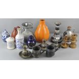 A collection of pottery vases and candlesticks of varying shapes and designs,