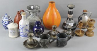 A collection of pottery vases and candlesticks of varying shapes and designs,