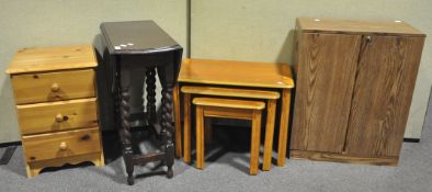 A nest of three tables, 65cm wide; a twin door cupboard,