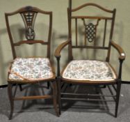 Two Edwardian mahogany salon chairs, with decorative pierced splats,