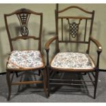 Two Edwardian mahogany salon chairs, with decorative pierced splats,