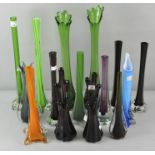 A large collection of vintage glass stem vases in various colours,