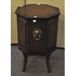 A mahogany side table with leather top and decorative handle,