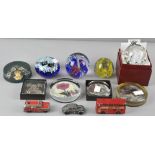 A collection of assorted glass paperweights to include some pictorial examples,