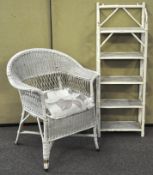 A white painted wicker chair along with a set of painted bamboo shelves,