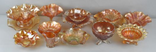 A collection of orange carnival glass items, mostly bowls and dishes,