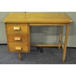 A 20th Century beech veneered desk having bank of three drawers,