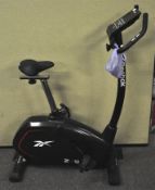 A Reebok exercise bicycle with digital read out,