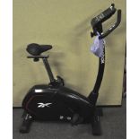 A Reebok exercise bicycle with digital read out,