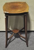 An Edwardian mahogany occasional table with flared feet,