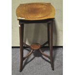 An Edwardian mahogany occasional table with flared feet,