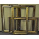 A group of four large gilt picture frames with varying decoration,