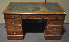 A reproduction twin pedestal desk with green leather top and three frieze drawers,