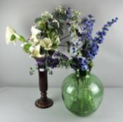 A green glass bottle garden, a vase and silk flowers. Largest; 44cm high.