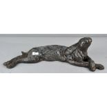 A large modernist stylized bronzed resin figure of a recumbent hare,