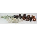 A collection of Bovril and period ink bottles in brown glass and clear. Tallest measures; 11cm.