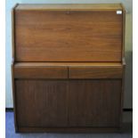 A 1970's Teak wood Remploy bureau, fall front door with fitted interior, over two draws and cover,
