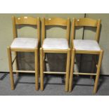 A set of Three beech wood bar stools, faux leather seat,