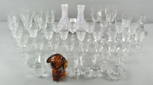 A collection of glassware, including a candlestick and drinking glasses,