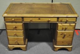 A pine pedestal desk with leather inset top,