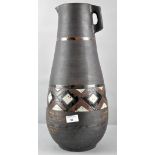 An Art pottery matt glazed retro jug with a glazed band of abstract designs,