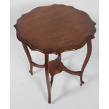 An Edwardian shaped mahogany occasional table with four cabriole legs stretchered to a centre shelf