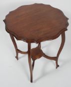 An Edwardian shaped mahogany occasional table with four cabriole legs stretchered to a centre shelf