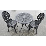 A cast aluminium painted black garden table and chairs,