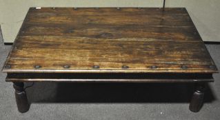 An Anglo-Indian brass bound wooden coffee table. Measures; 41cm x 135cm x 91cm.