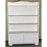 A white painted bookcase on bun feet, Measures; 107cm high.