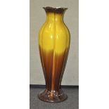 A large pottery floor vase, glazed in graduated yellow and brown, 82 cm high, a/f foot damaged.