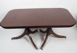 A Regency style mahogany twin pedestal extending dining table,