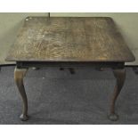 An oak wind out dining table on cabriole legs,