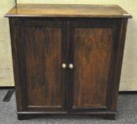 A 19th century mahogany plain two door side cabinet, raised on shaped bracket feet,