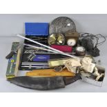 An assortment of various collectables, including a Kukri knife, mercury filled clock pendulum,