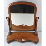 A Victorian mahogany dressing table mirror, raised upon turned bun feet,