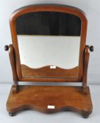A Victorian mahogany dressing table mirror, raised upon turned bun feet,