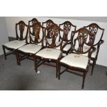 A group of eight stained oak shield back style dining chairs with pierced vase splats