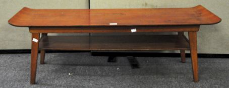 A 1960's stained beech veneered surf board coffee table with under shelf,