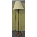 An early 20th Century oak turned standard lamp on round base,